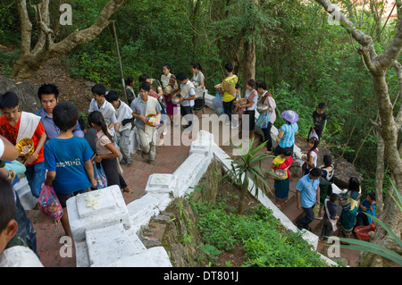 Pilgrims making their way up to Wat Tham Phousi with offerings, Mount Phousi, Lao New Year (Pi Mai Lao), Luang Prabang, Laos Stock Photo