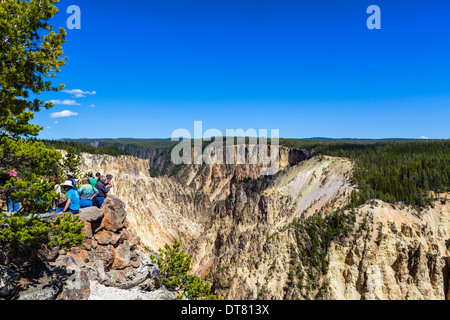 Tourists at Grand View on North Rim overlooking the Grand Canyon of the Yellowstone, Yellowstone National Park, Wyoming, USA Stock Photo