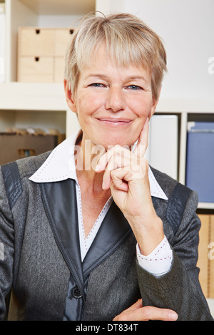 Portrait of an happy smiling senior business woman in the office Stock Photo