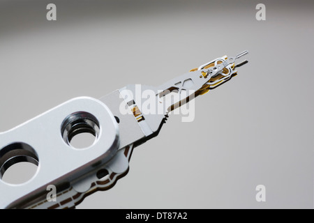 Close up of computer hard disk drive read head on a hard disk platter. Stock Photo