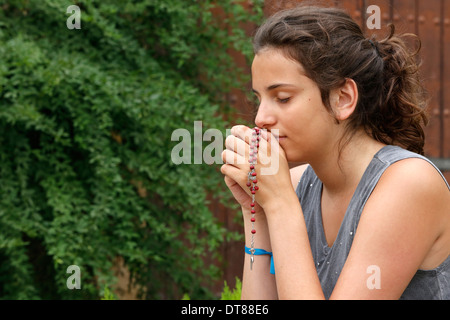 Praying teenager Stock Photo