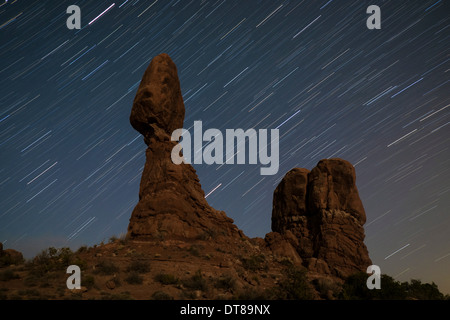 Balanced Rock against a backdrop of star trails in Arches National Park near Moab, Utah. Stock Photo