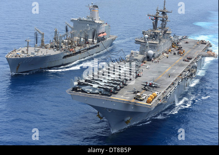 USNS Laramie an USS Kearsarge conduct a replenishment at sea. Stock Photo