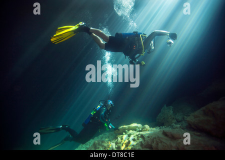 A young married couple scuba diving in Devil's Den Springs Florida. Stock Photo