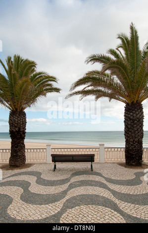 cobbled promenade by the beach of Praia da Luz in the western Algarve region of Portugal Stock Photo