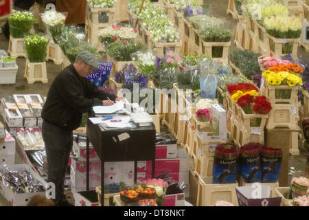 Vauxhall London, UK. 12th February 2014. A wholesale vendor  writes orders from buyers in New Covent Garden a few days running up to St Valentines Day. New Covent Garden  Flower Market is London's premier market stocking a wide range of flowers and plants  The British people  are expected spend  more than 50 million pounds on flowers for Valentines with 99 percent on roses Credit:  amer ghazzal/Alamy Live News Stock Photo