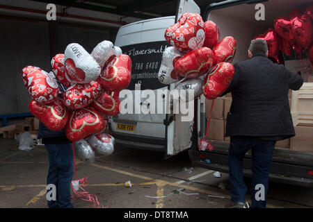 Vauxhall London, UK. 12th February 2014. Wholesale vendors load Valentine balloons onto a truck in New Covent Garden a few days running up to St Valentines Day. New Covent Garden  Flower Market is London's premier market stocking a wide range of flowers and plants  The British people  are expected spend  more than 50 million pounds on flowers for Valentines with 99 percent on roses Credit:  amer ghazzal/Alamy Live News Stock Photo