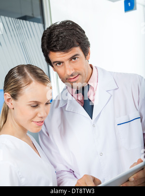 Technician And Colleague Using Digital Tablet Stock Photo