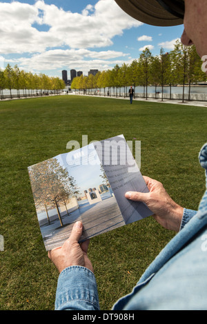 Tourist Reading Brochure in Four Freedoms Park on Roosevelt Island, New York, USA Stock Photo