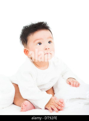cute newborn infant baby sitting and looking over white Stock Photo