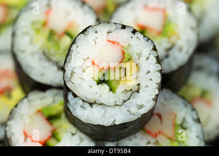 Extreme horizontal Closeup photo of a single California hand roll sushi with focus in center Stock Photo