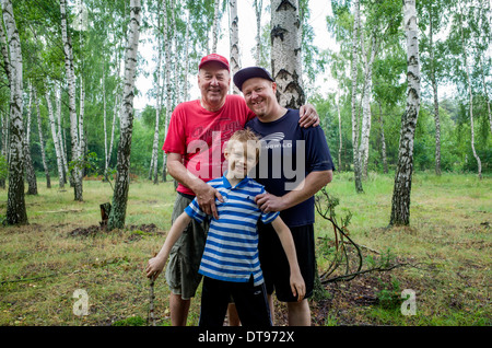 Family of three generations enjoying a moment in the Polish woods. Zawady Central Poland Stock Photo