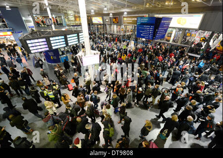 MANCHESTER, UK. 12th February, 2014. Manchester Piccadilly train station concourse during strong winds across the United Kingdom, which led to to travel disruption for evening commuters. Some travellers were advised to postpone their travel plans for the day. Credit:  Russell Hart/Alamy Live News. Stock Photo