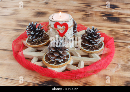 Advent wreath with red stripes wrap around candle holders made of Birch wood Stock Photo