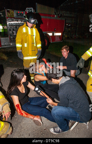 Regional Occupation Program (ROP) students perform first aid on classmates posing as crime victims in crime investigation class. Stock Photo