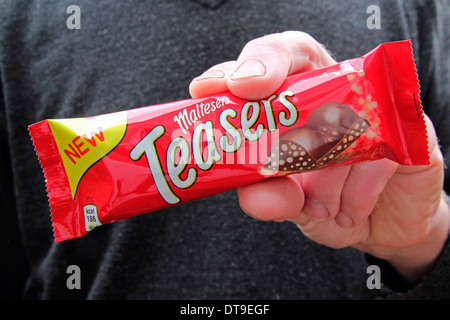 Caucasain Man Holding a Maltesers Teasers Chocolate Bar, UK MODEL RELEASED Stock Photo