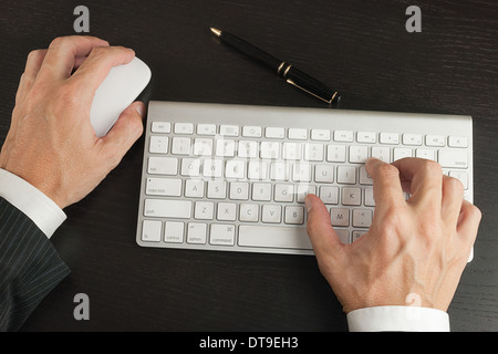 Close-up of a businessman working on a computer, shot from above, close. Stock Photo