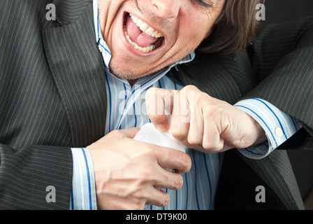 Close-up of a casual businessman trying to open a pill bottle. Stock Photo