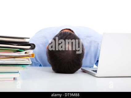 Exhausted businessman falling asleep at his office desk Stock Photo