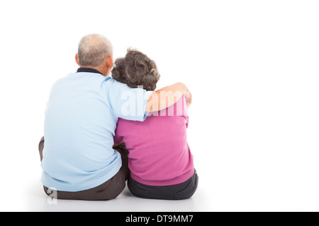 Happy closeness senior couple sitting on the floor over white background Stock Photo