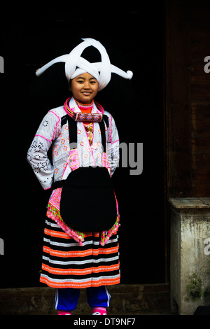 A Long Horn Miao little girl in traditional costumes dancing to celebrate the Tiao Hua festival / spring festival in Guizhou. Stock Photo