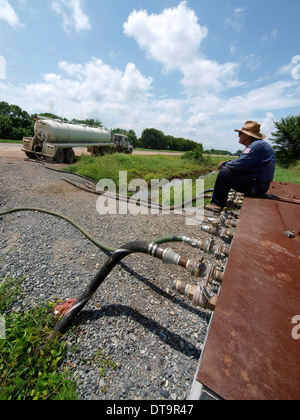 Driver waits to get water truck filled with fresh water from a 'hydrant' in DeSoto Parish that pipes fresh water from Shreveport Stock Photo