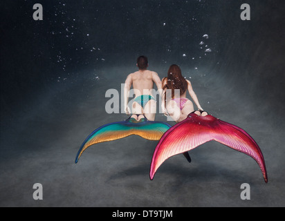 Mertailor and a Mermaid swimming in Mertailor flukes in a pool in Virginia Beach, Virginia Stock Photo