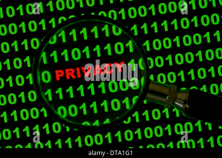 Binary code with the word "Privacy" viewed through a magnifying glass Stock Photo