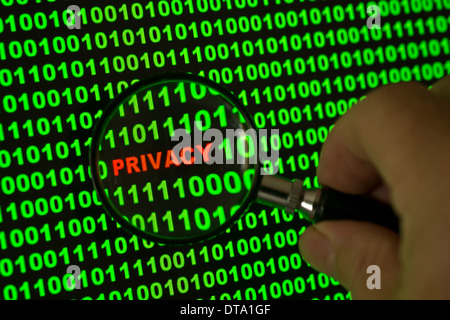 Binary code with the word "Privacy" viewed through a magnifying glass Stock Photo