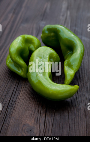 Three pods of hot green peppers on burlap, close-up, top view Stock ...