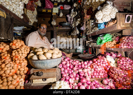 Man selling potatoes and onions at Crawfort Market, Mumbai, Maharashtra, India Stock Photo