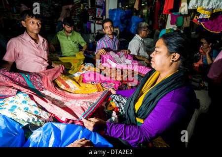 A woman is buying material at Mangaldas Market, Mumbai, Maharashtra, India Stock Photo