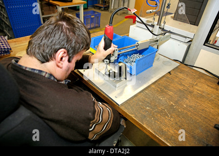 Mentally and physically disabled man at work Stock Photo