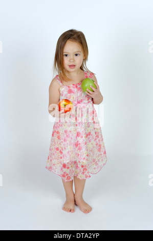 Girl with a red and a green apple Stock Photo