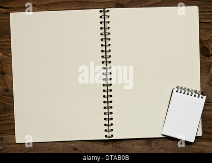 Blank ring bound scrapbook on a rustic wooden background with copy space for insertion of your message or design elements. Stock Photo