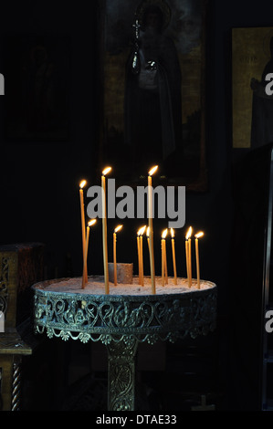 Vintage byzantine manouali candle stand in dark orthodox church interior. Stock Photo