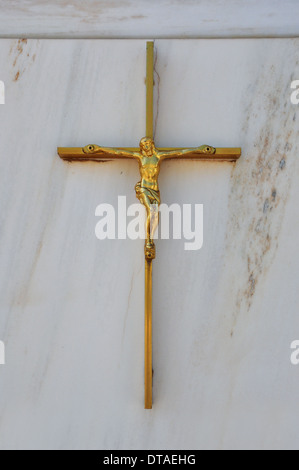 Golden crucifix on marble background. Jesus Christ on the cross religious symbol. Stock Photo