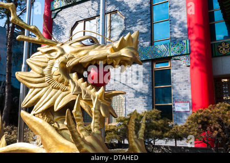 Golden dragon statue outside of a building in the Chinatown district of Incheon, South Korea. Stock Photo