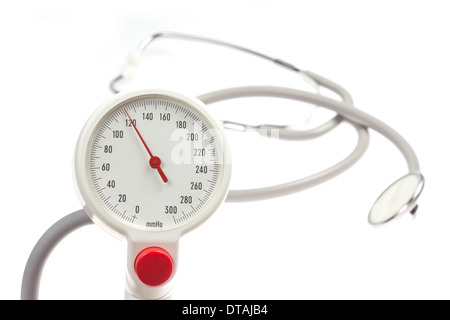 manometer of a blood pressure cuff showing with a stethoscope in the background isolated on white background Stock Photo