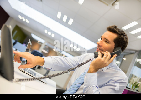 Businessman on phone in startup Stock Photo