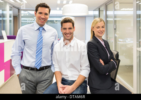 Portrait of smiling business team in office, looking camera Stock Photo