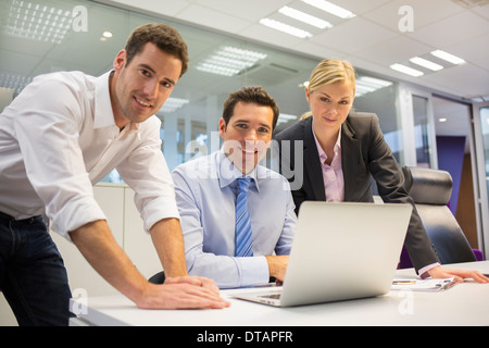 A business team of three in office and planning work, looking camera Stock Photo