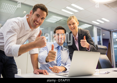 Happy business team in a office celebrating a success, looking camera Stock Photo