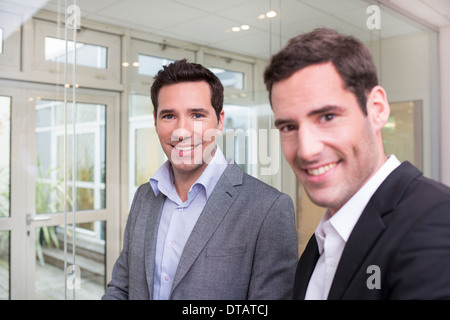 Portrait of Two smiling businessmen in office, looking camera Stock Photo