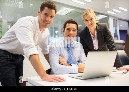 A business team of three in office and planning work, looking camera Stock Photo