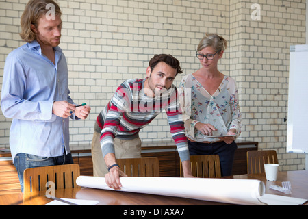 Office colleagues discussing on plan Stock Photo