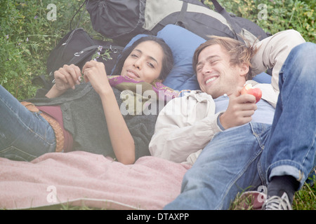 Young couple relaxing in field Stock Photo