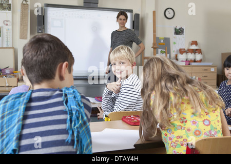 Teacher and students in classroom Stock Photo