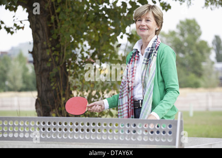 Mature woman playing table tennis Stock Photo