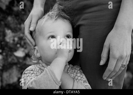 Baby boy with mother, looking away Stock Photo